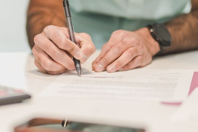 person signing a document
